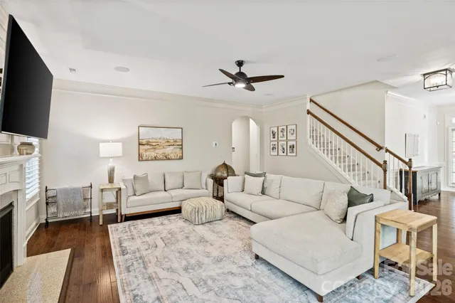 a living room with furniture a fireplace and a flat screen tv