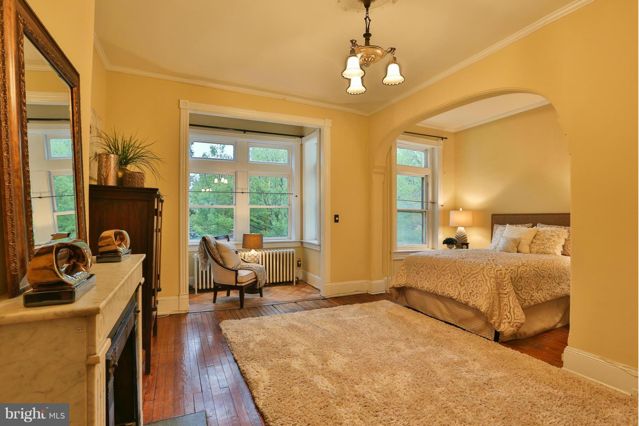 436 New Jersey Avenue Southeast Washington, DC 20003 - Photo 5 of 13 a spacious bedroom with a bed and wooden floor