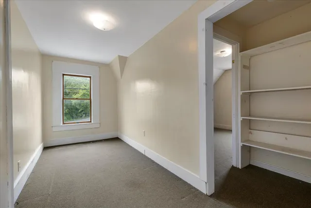 a kitchen with a wooden floor and a refrigerator