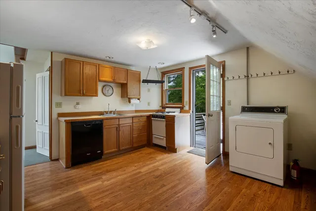 a roof deck with table and chairs and wooden floor