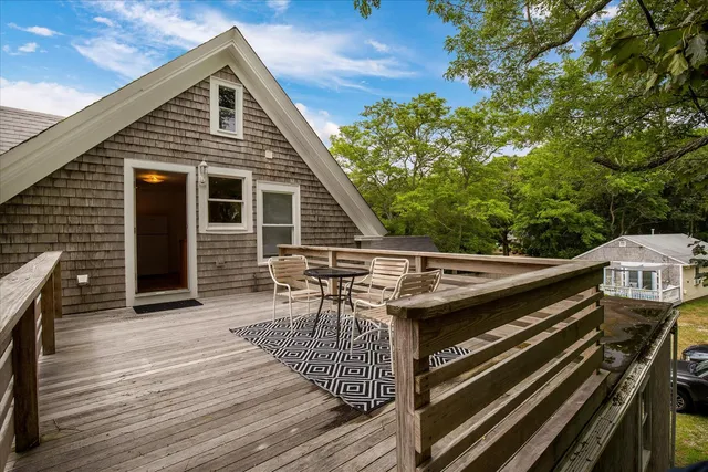 a balcony with table and chairs