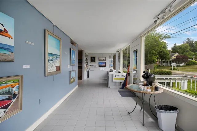 a living room with furniture and large windows