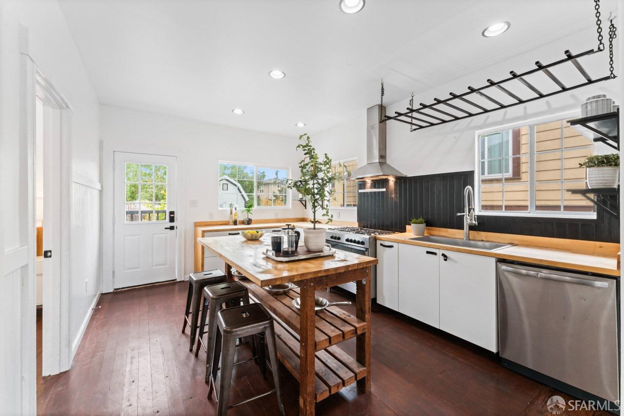 1718 37th Avenue Oakland, CA 94601 - Photo 16 of 33 a kitchen with a table and chairs in it