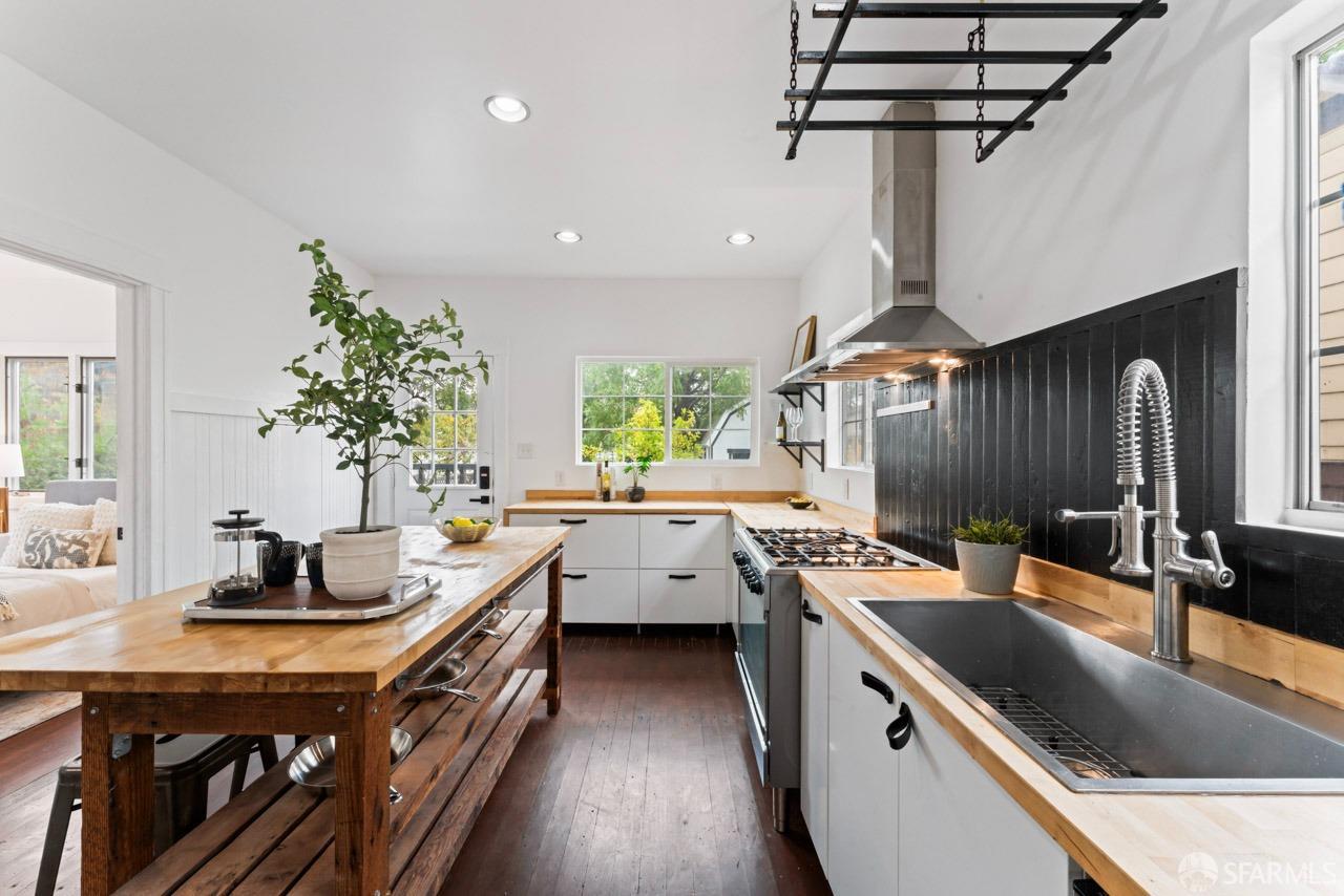 1718 37th Avenue Oakland, CA 94601 - Photo 19 of 33 a kitchen that has a sink and chairs