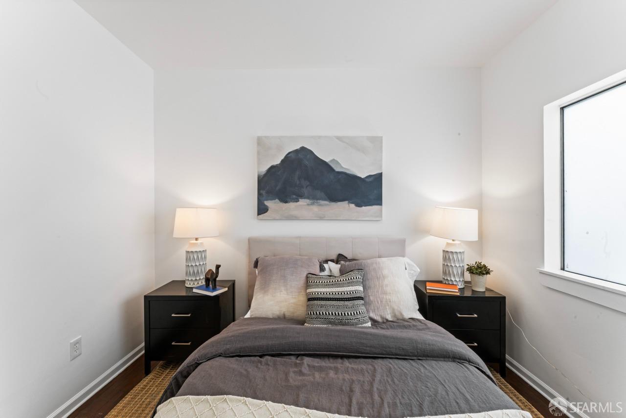 1718 37th Avenue Oakland, CA 94601 - Photo 21 of 33 a bedroom with a bed and a lamp