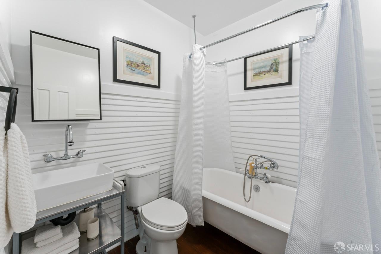 1718 37th Avenue Oakland, CA 94601 - Photo 22 of 33 a bathroom with a toilet a sink and mirror