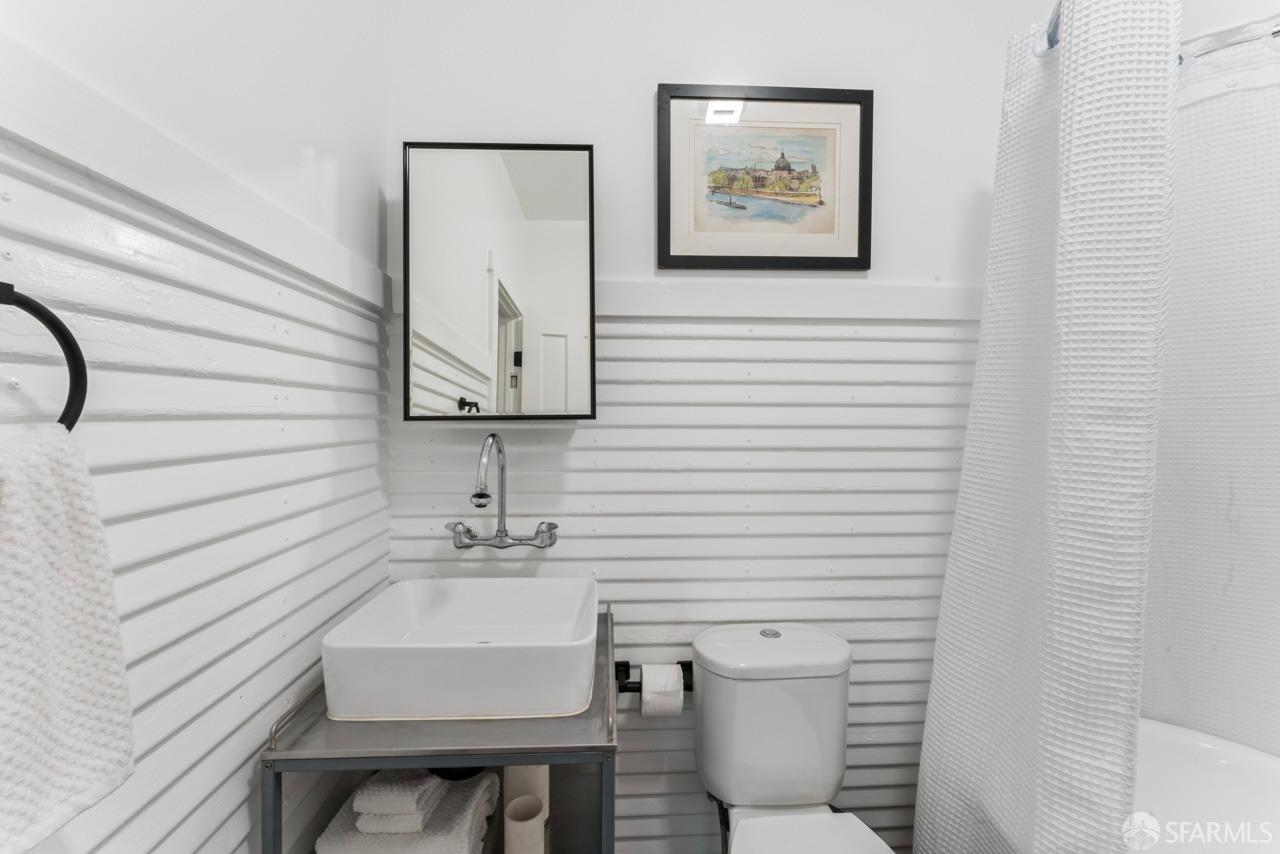 1718 37th Avenue Oakland, CA 94601 - Photo 23 of 33 a bathroom with a toilet and a sink