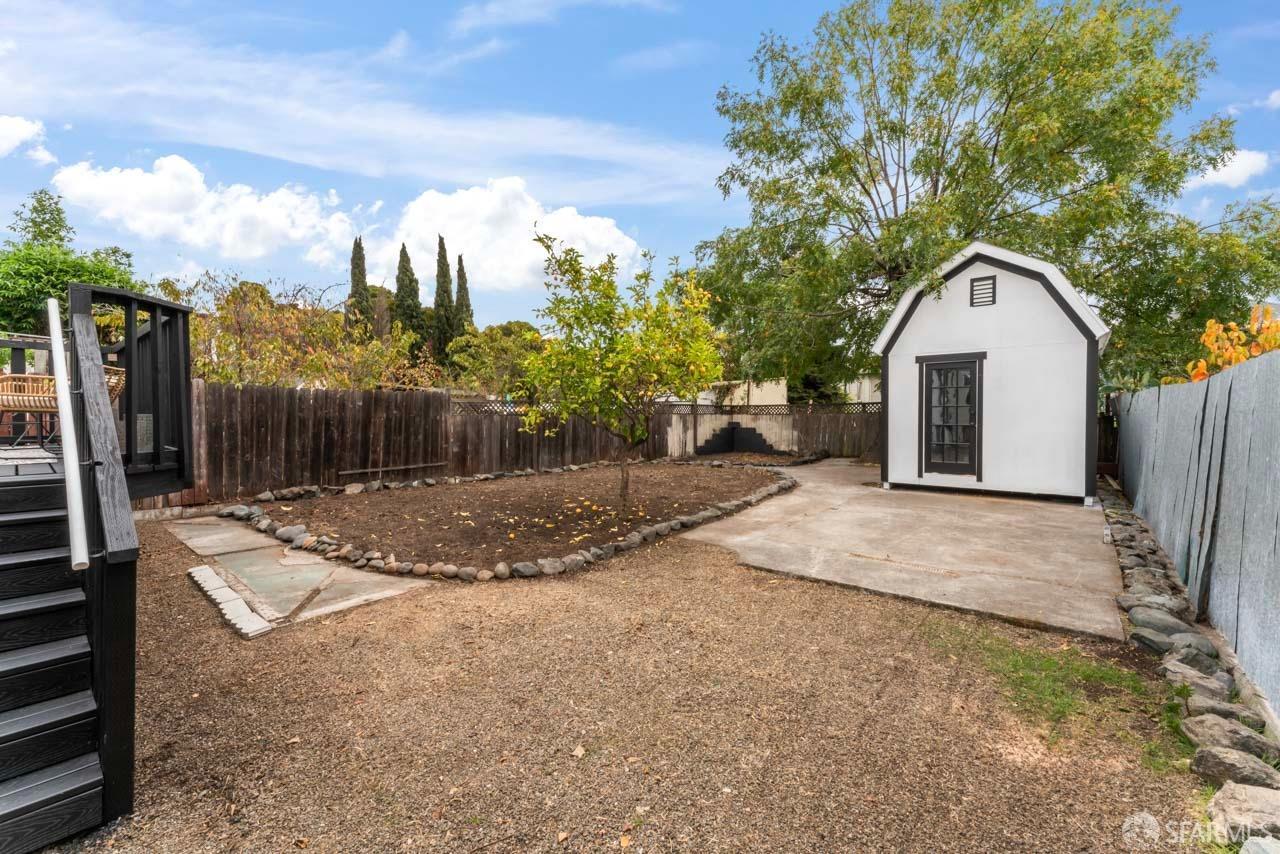 1718 37th Avenue Oakland, CA 94601 - Photo 28 of 33 a view of a white house with a yard and large tree