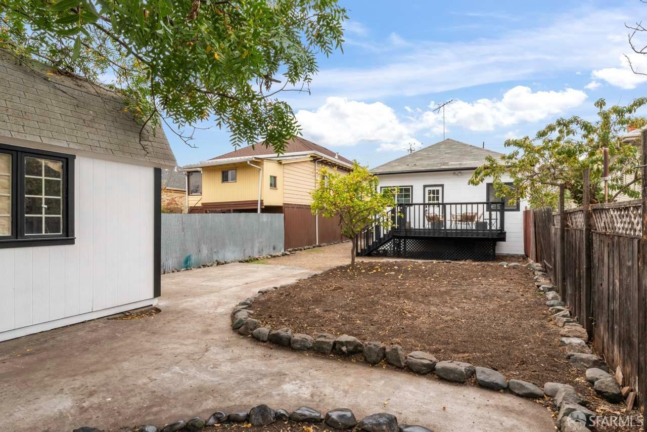 1718 37th Avenue Oakland, CA 94601 - Photo 32 of 33 a view of a house with a yard and large tree