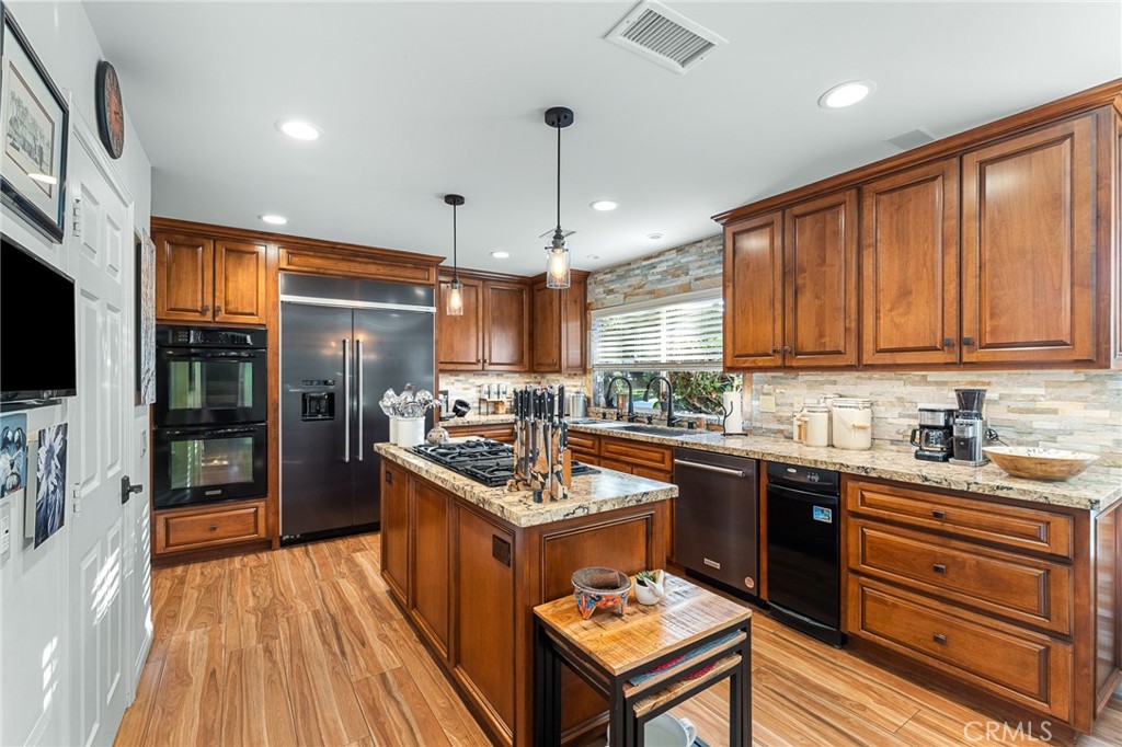 1457 Crestview Road Redlands, CA 92374 - Photo 19 of 60 Remodeled kitchen with quarzite counters, wood grained tile flooring, gourmet appliances.