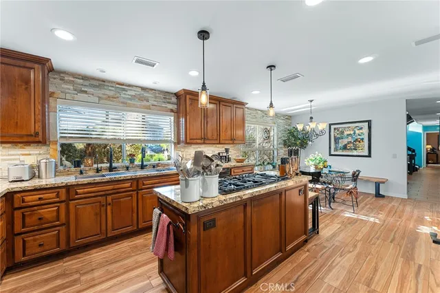 a kitchen with stainless steel appliances granite countertop a sink and cabinets