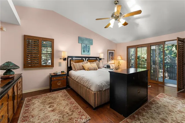 a living room with lots of furniture a chandelier a rug and a window
