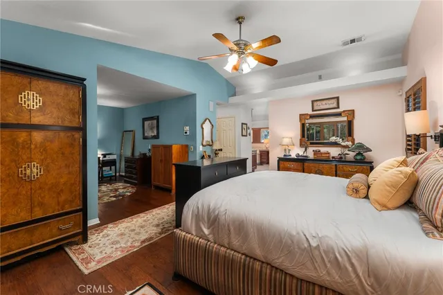 a bedroom with a bed a couch and a window