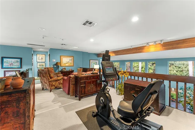 a dining room with furniture entryway and wooden floor