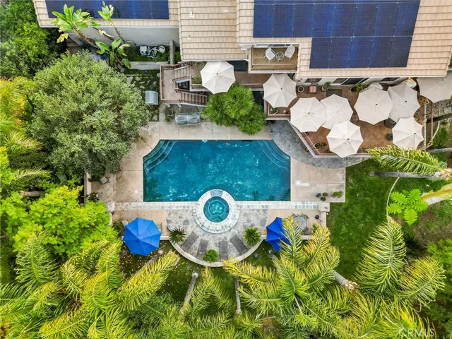 a backyard of a house with dining table and chairs