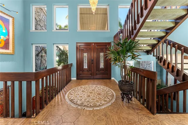 a living room with furniture a rug and a chandelier