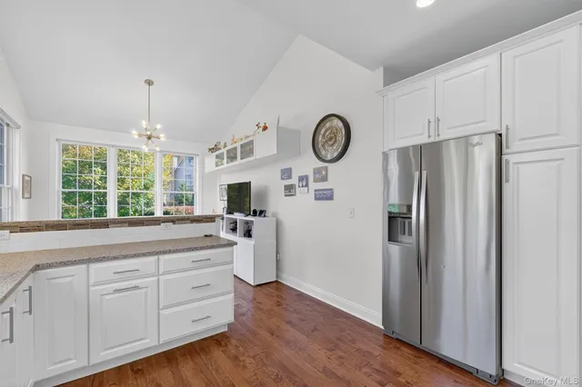 a kitchen with cabinets and window