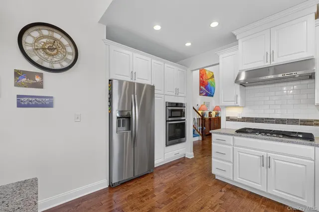a kitchen with stainless steel appliances a stove and a refrigerator