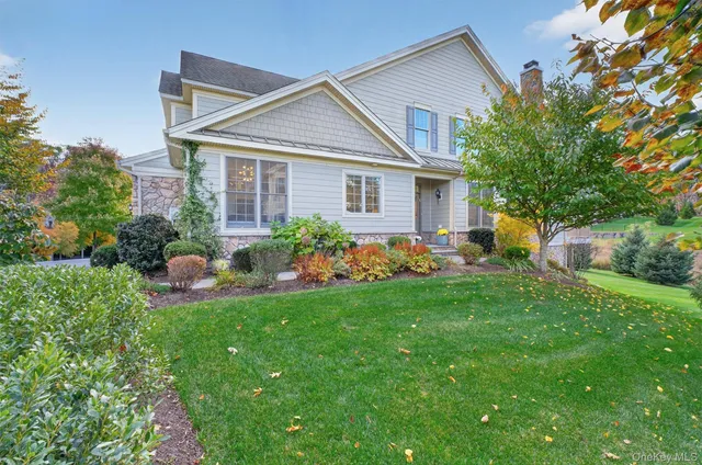 a front view of house with a garden