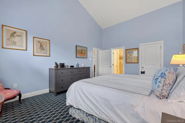 a spacious bedroom with a bed and wooden floor