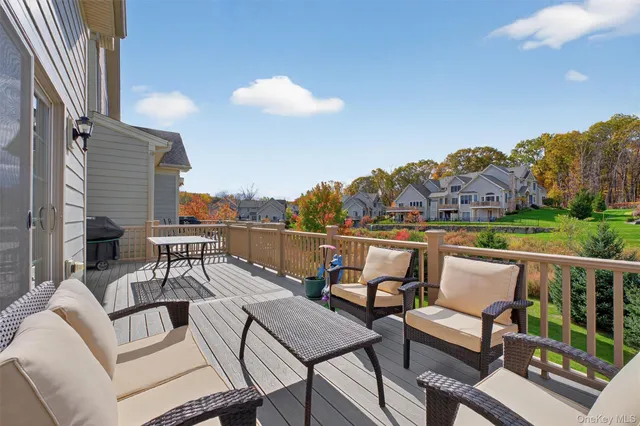 a balcony with outdoor seating and city view