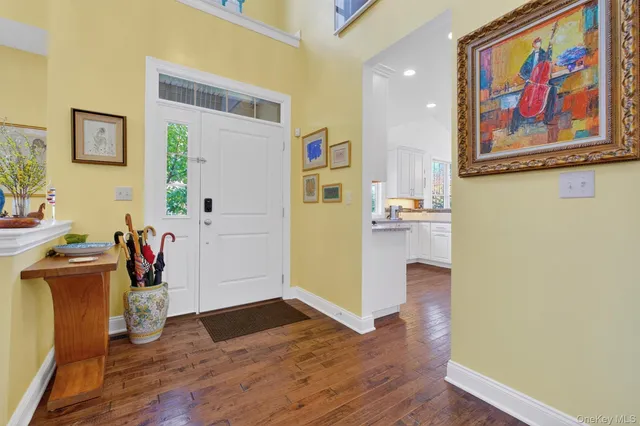 a view of a room with wooden floor and furniture