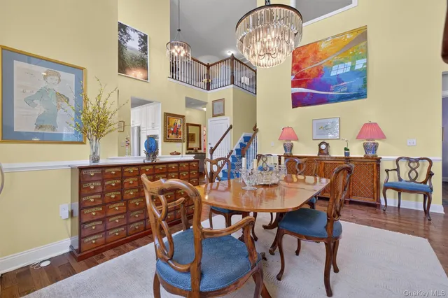 a view of a dining room with furniture wooden floor and a chandelier