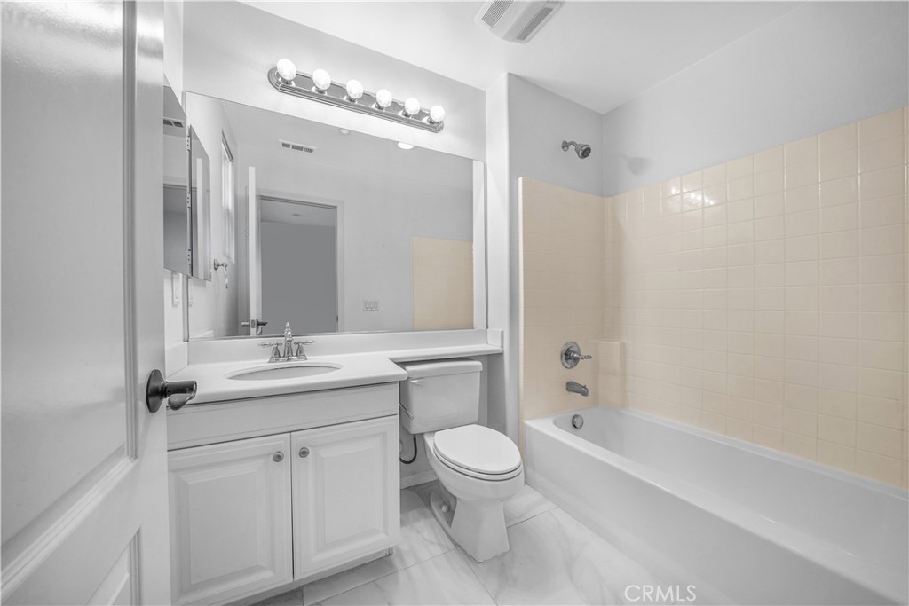 5 Arlington Street Ladera Ranch, CA 92694 - Photo 22 of 26 a bathroom with a toilet a sink a tub and mirror