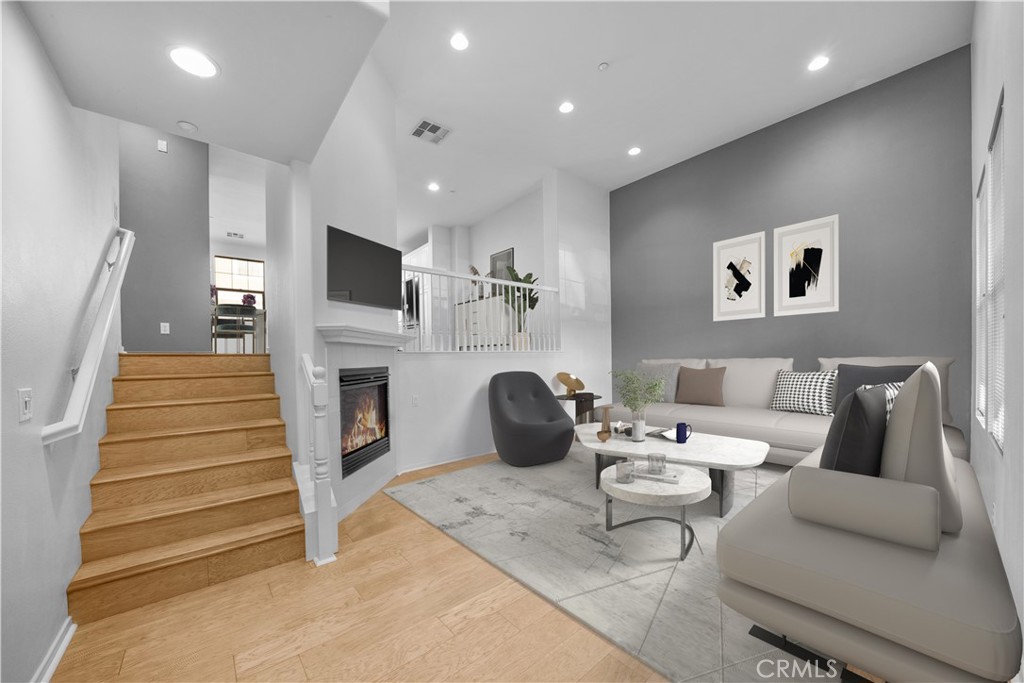 5 Arlington Street Ladera Ranch, CA 92694 - Photo 4 of 26 a living room with furniture a fireplace and a flat screen tv