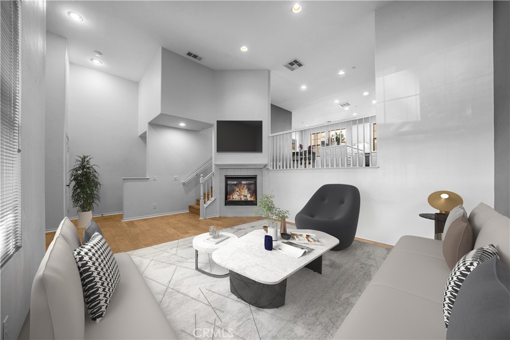 5 Arlington Street Ladera Ranch, CA 92694 - Photo 5 of 26 a living room with furniture and a fireplace