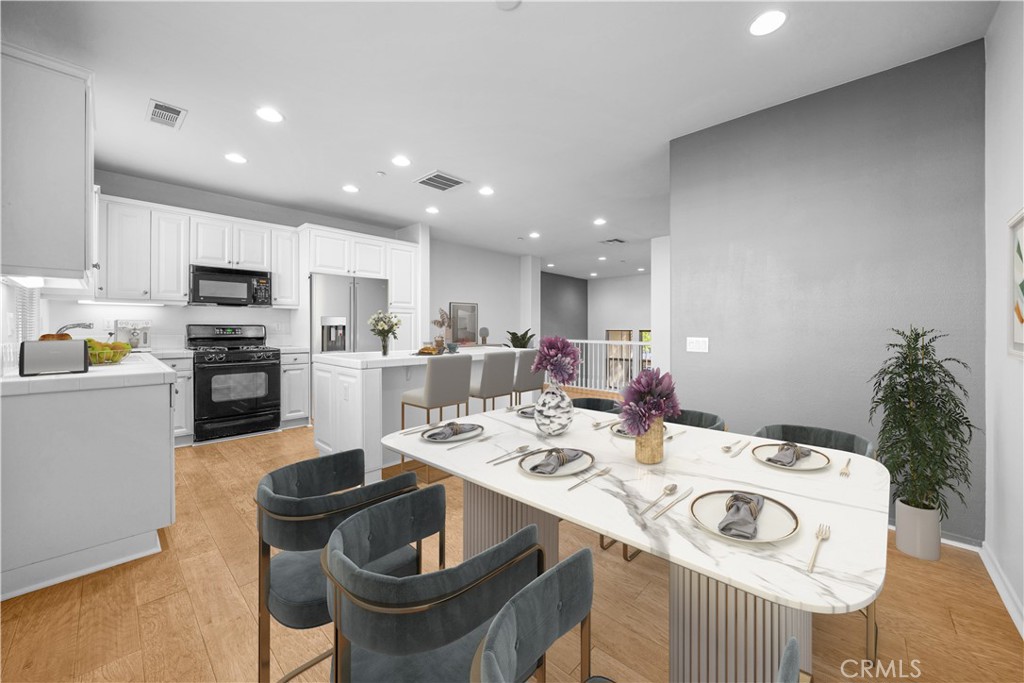 5 Arlington Street Ladera Ranch, CA 92694 - Photo 8 of 26 a kitchen with a sink and chairs
