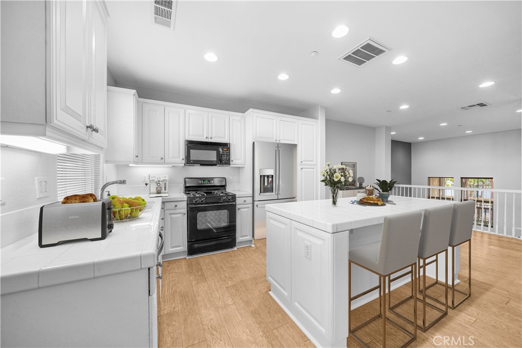 5 Arlington Street Ladera Ranch, CA 92694 - Photo 9 of 26 a kitchen with counter space appliances and cabinets