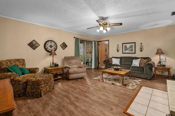 a living room with lots of furniture and wooden floor