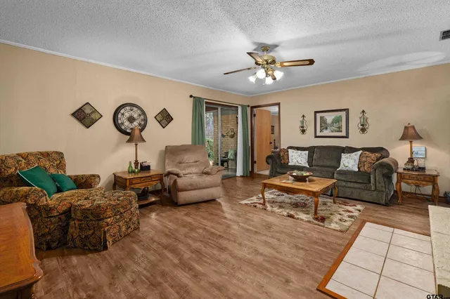 a living room with lots of furniture and wooden floor