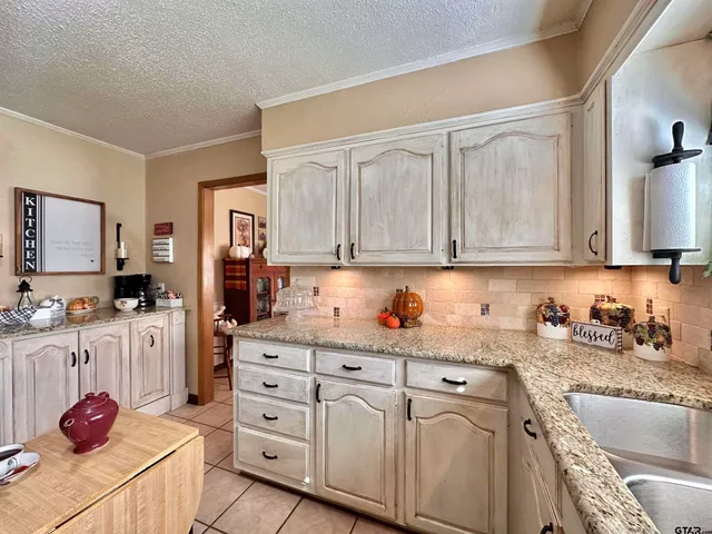 a kitchen with stainless steel appliances granite countertop a sink dishwasher stove and cabinets