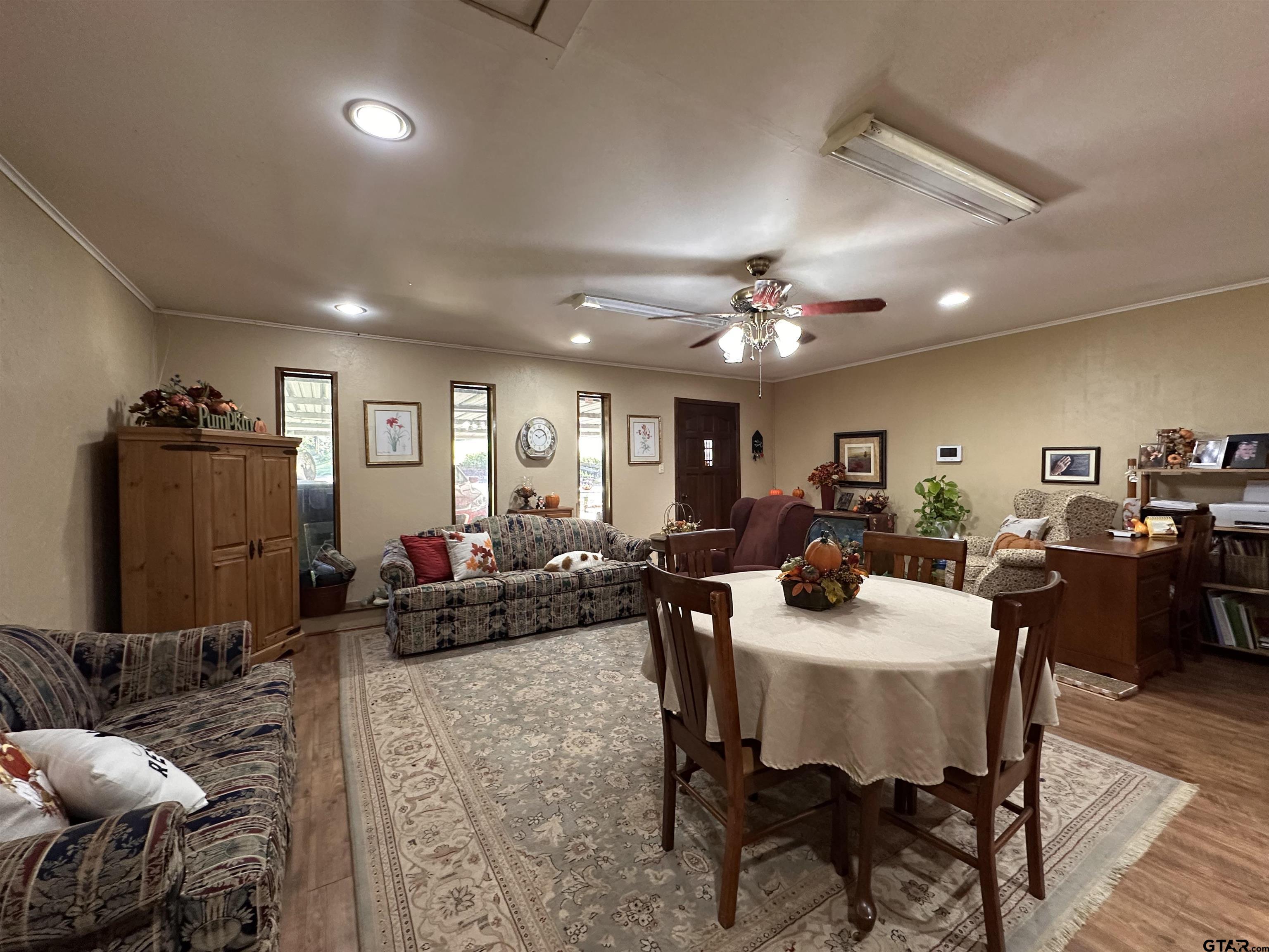 3501 Boyd Road Longview, TX 75604 - Photo 15 of 40 a living room with furniture and a chandelier