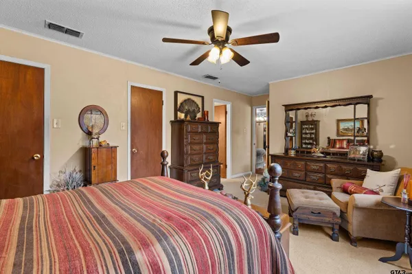 a view of a house with pool and chairs