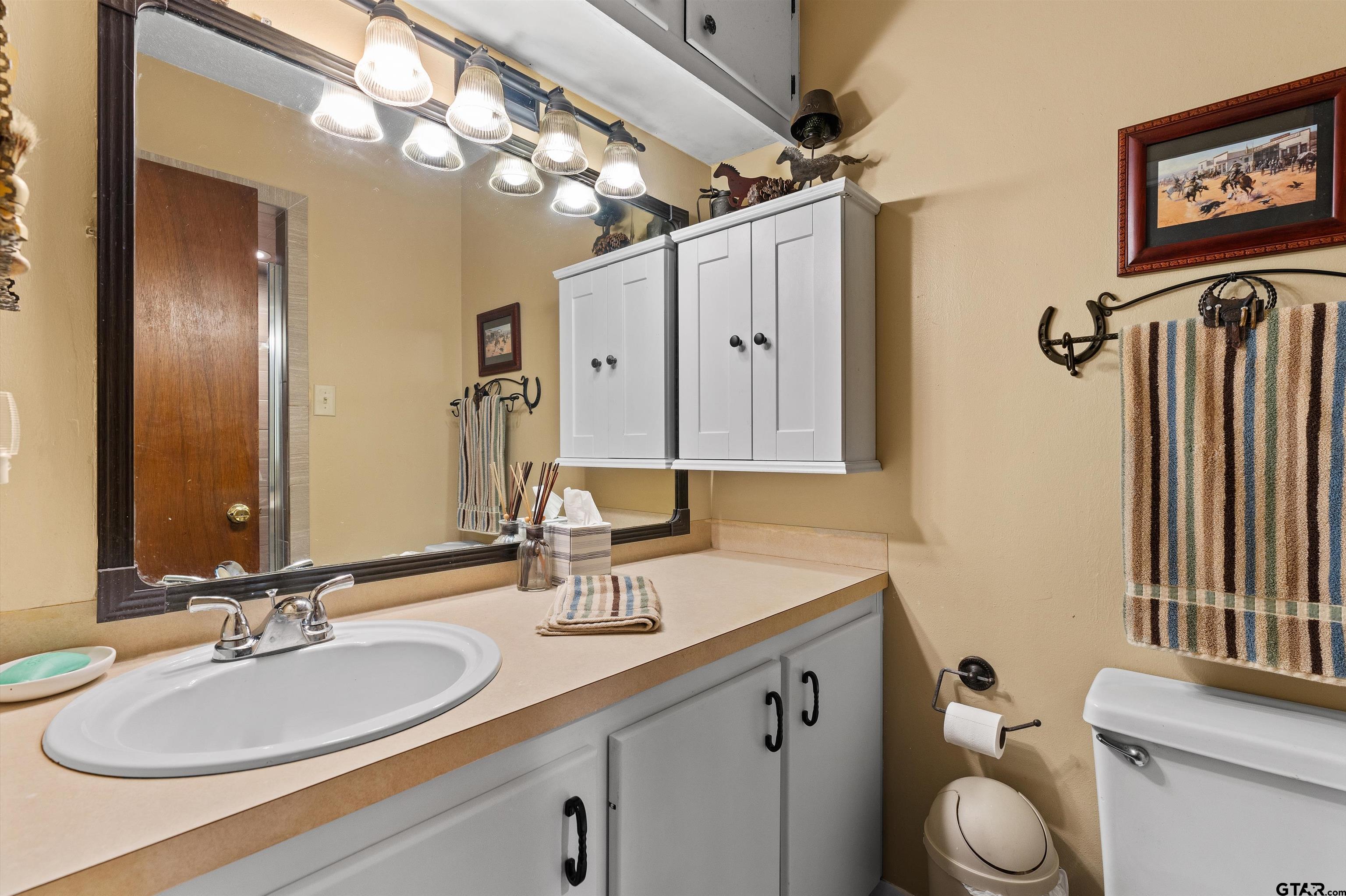 3501 Boyd Road Longview, TX 75604 - Photo 16 of 39 a bathroom with a double vanity sink mirror and toilet