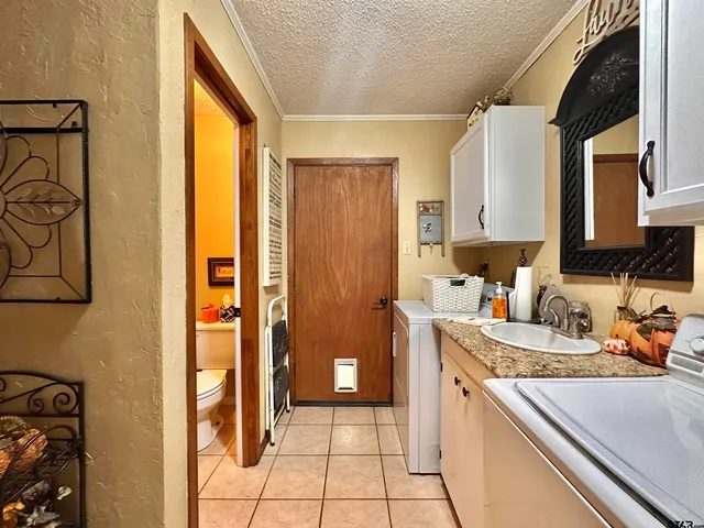 a kitchen with a sink and a refrigerator