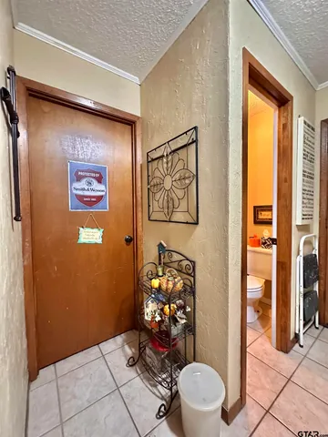 a bathroom with a toilet and a shower curtain
