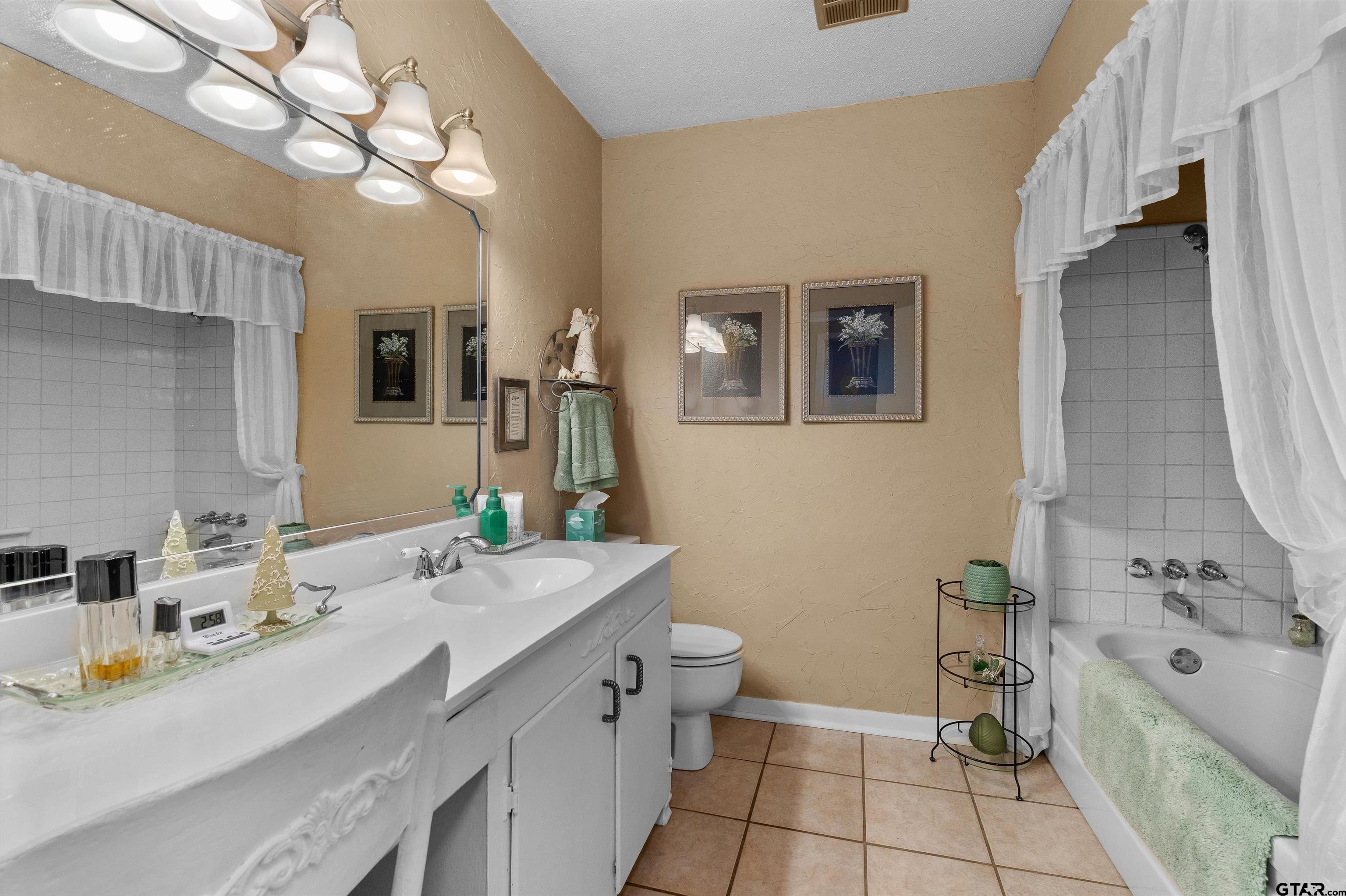 3501 Boyd Road Longview, TX 75604 - Photo 19 of 39 a bathroom with a sink double vanity and a mirror