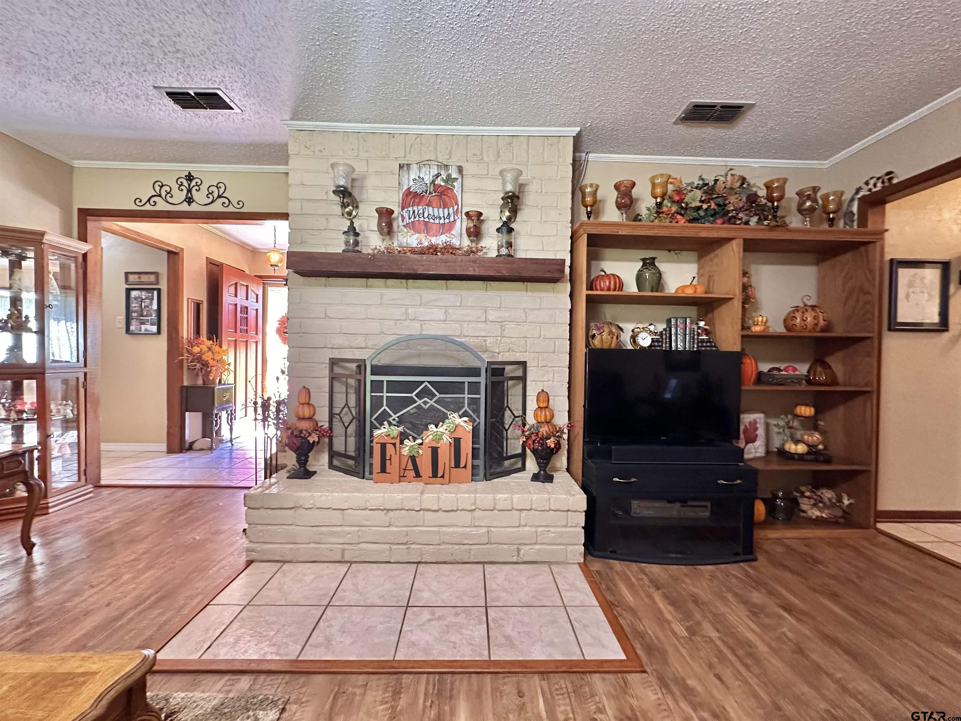 3501 Boyd Road Longview, TX 75604 - Photo 22 of 40 a living room with furniture a flat screen tv and a fireplace