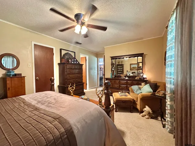 a bedroom with a bed and ceiling fan