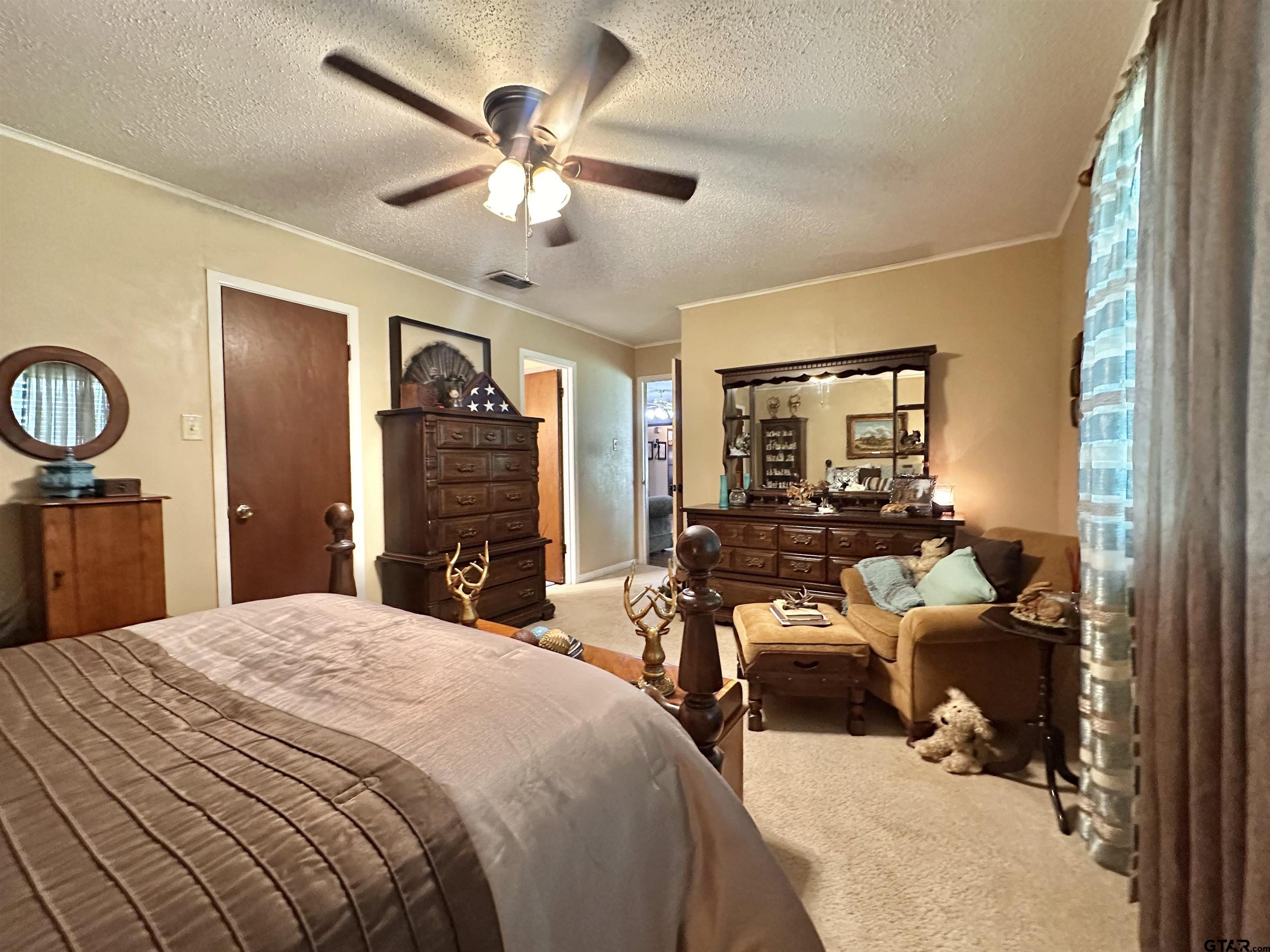 3501 Boyd Road Longview, TX 75604 - Photo 24 of 40 a bedroom with a bed and ceiling fan