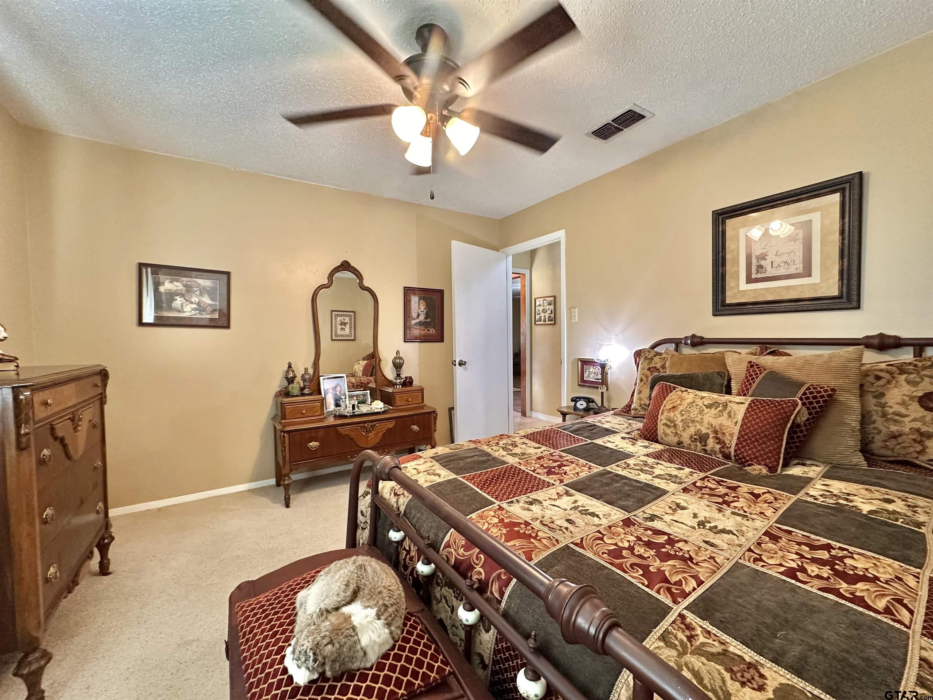3501 Boyd Road Longview, TX 75604 - Photo 29 of 40 a bedroom with a bed and a chandelier