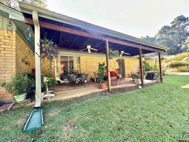 a view of a house with a backyard and a patio