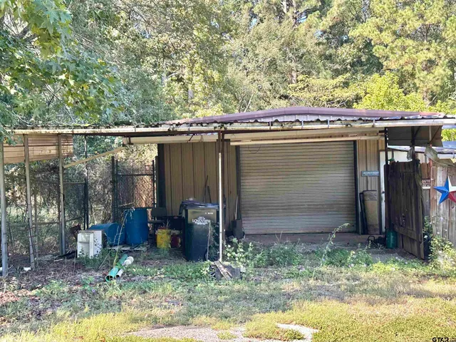 a backyard of a house with barbeque oven
