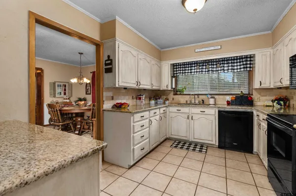 a bedroom with bed and a large mirror