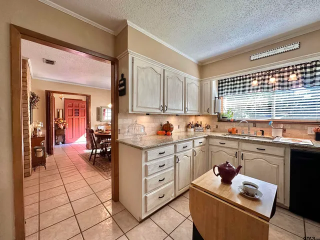 a kitchen with cabinets appliances and a window