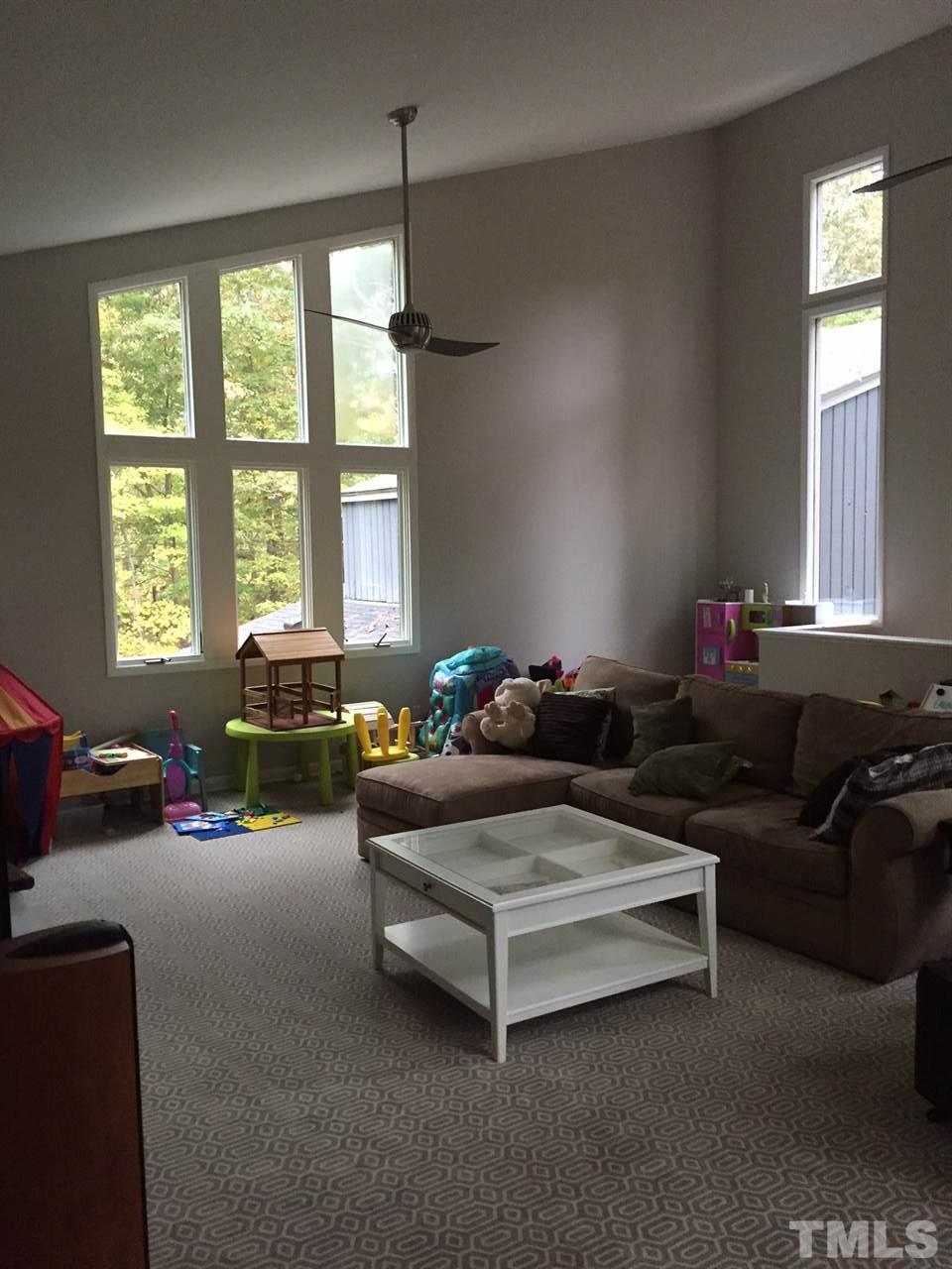 5400 Sylvan Lane Raleigh, NC 27613 - Photo 2 of 24 a living room with furniture and a chandelier